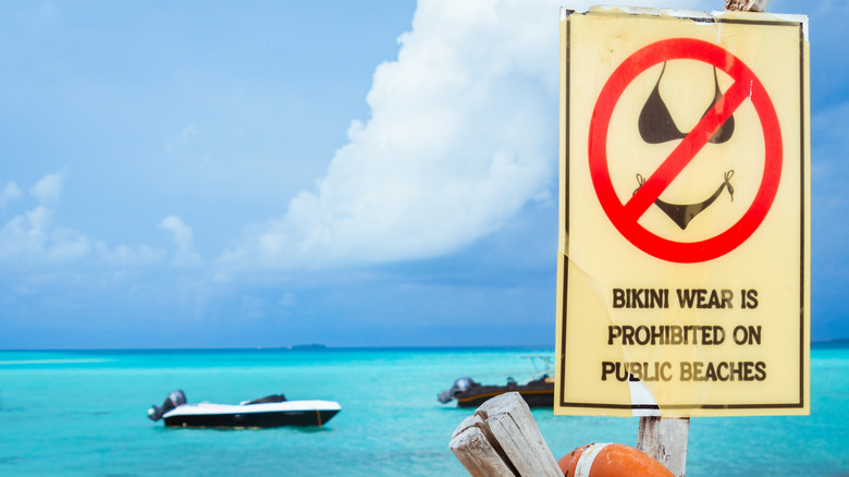 Fulidhoo, Maldives - 5th may, 2024: notice signpost "Bikini wear is prohibited on public beaches"