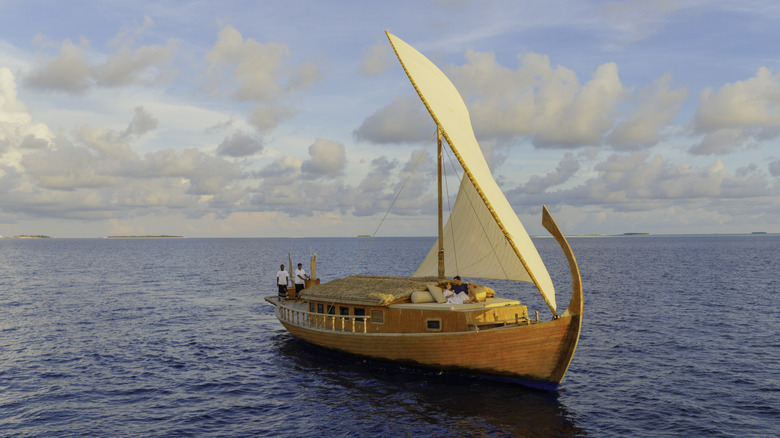 A couple enjoying a romantic cruise on a dhoni, a traditional Maldivian boat