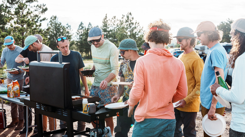 A group of men barbecuing together at a bachelor party