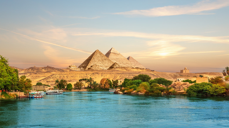 View on the Nile and the boats at sunset in the Aswan desert near the Pyramids of Egypt.