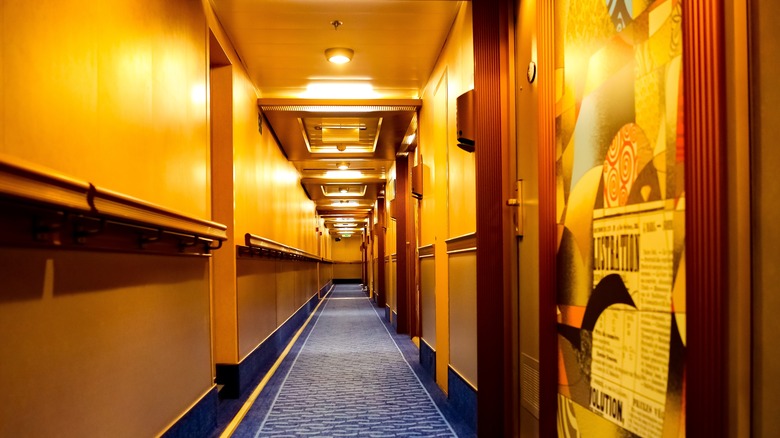View of guestroom hallway with blue carpeting