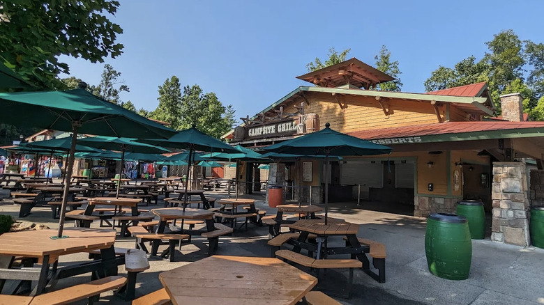 View of Campsite Grill exterior with empty dining tables at Dollywood's Splash Country water park