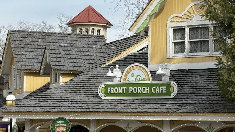 Exterior view of Victorian style Front Porch Cafe restaurant and signage at Dollywood theme park during Christmas