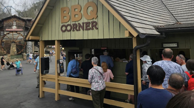 View of diners waiting in line at the quick-service Miss Lillian's BBQ Corner at Dollywood theme park on a cloudy day