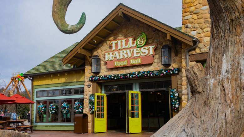Exterior view of Till & Harvest Food Hall restaurant inside Dollywood theme park at Christmas