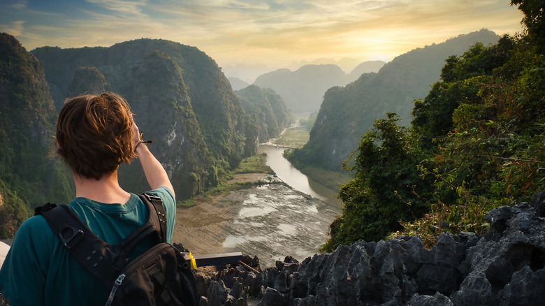 Tourist taking photos at sunset in Ninh Binh province, Vietnam.