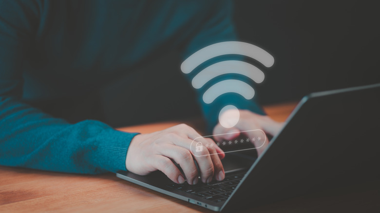 User on a computer laptop to connect to wifi in hotel.