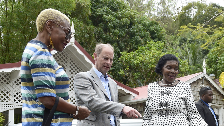 Prince Edward, the Earl of Wessex, chats with staff members