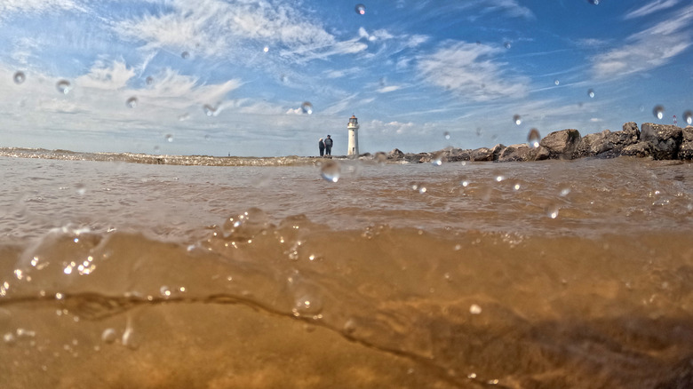 Close up view of water at Mercyside Beach, UK, which is one of the beaches impacted by sewage runoff