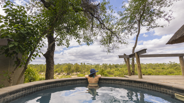 Woman lounging in pool outside