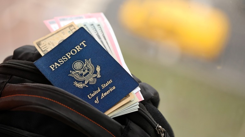 A traveler's carry-on with passport, money, and tickets
