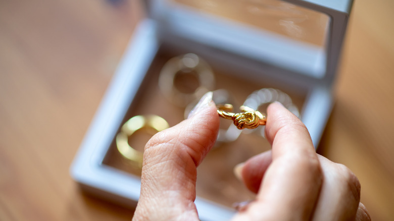 A woman getting her jewelry together for vacation