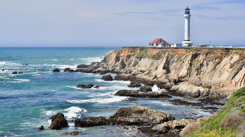 The Point Arena Lighthouse on California's Mendocino Coast and foamy sea below
