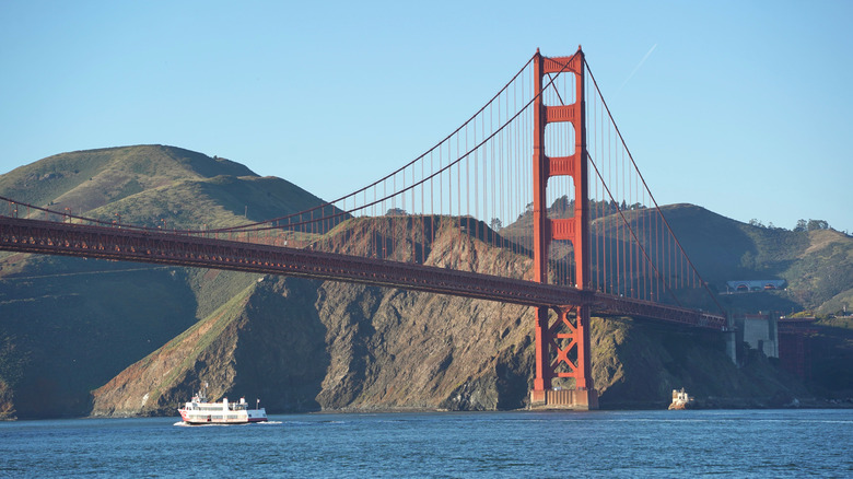 A ferry passes under the Golden Gate Bridge.