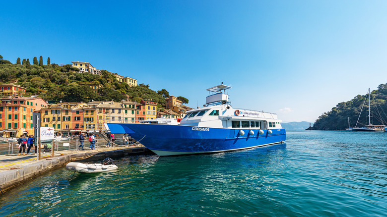A young woman watches the scenery from a ferry to Portofino.