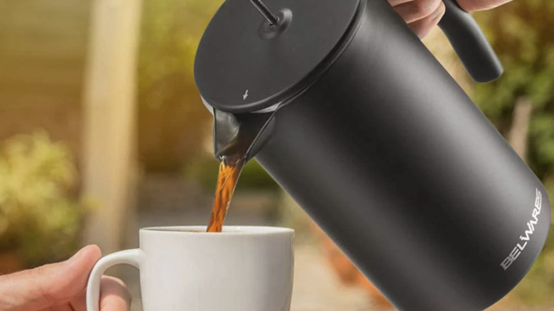 Someone pouring a coffee from a Belwares French Press Coffee Maker