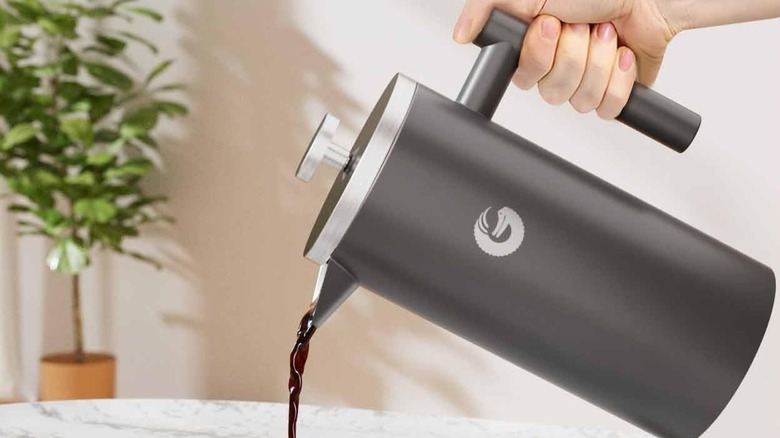 The Coffee Gator French Press with packaging and canister