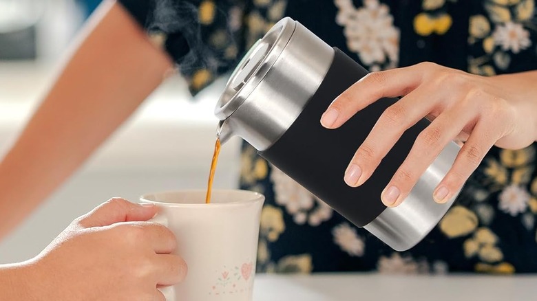 Hands pouring coffee from a MAGICAFÉ French Press