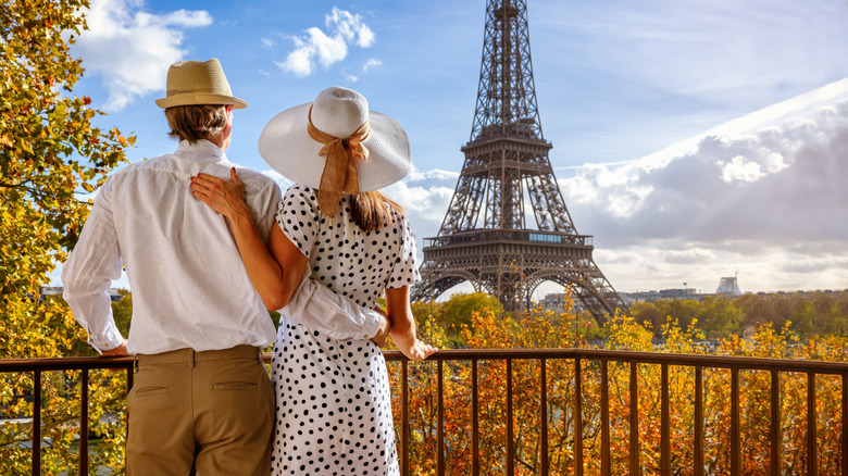 Tourists enjoying the Eiffel Tower in fall.