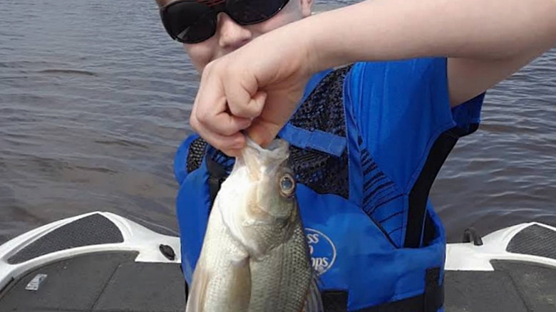 A child shows off his catch at Sam Rayburn Reservoir.
