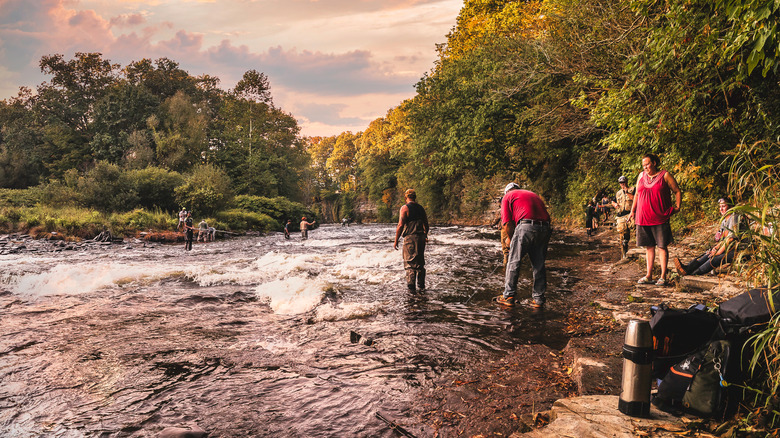 People fishing the Salmon River before sunset at Pulaski, New York.