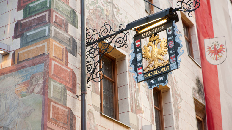 Signage for the historic Golden Adle Inn in the city of Innsbruck's Old Town