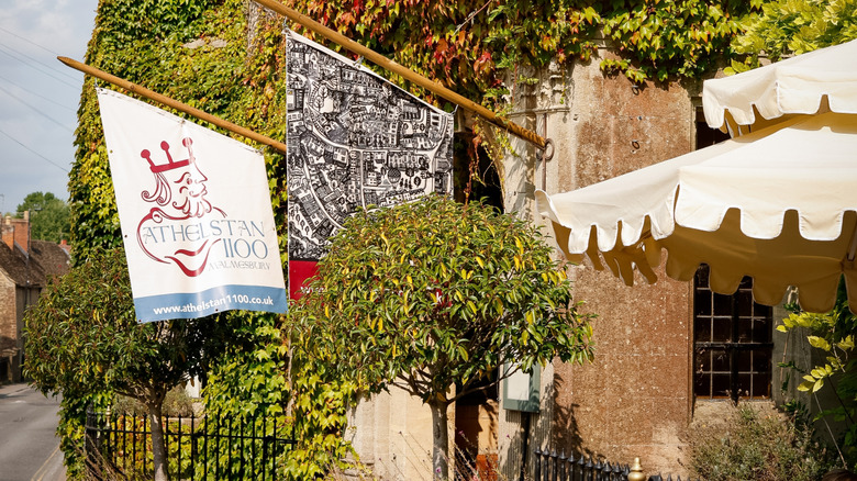 The entrance to the Old Bell Hotel in Malmesbury with flags blowing in the breeze