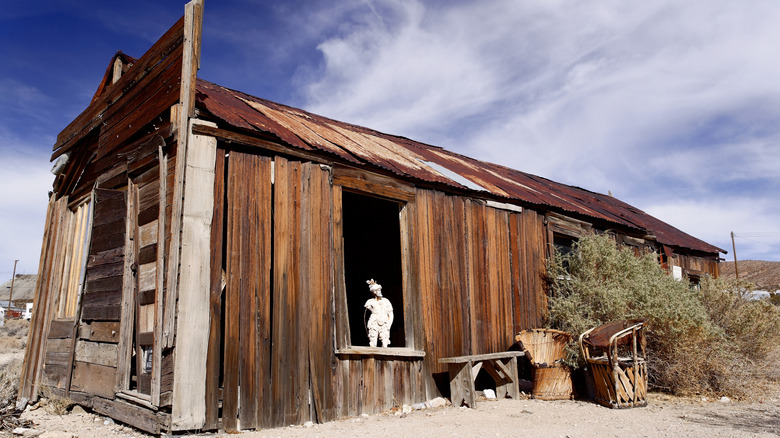 A statue sits in a window in the ghost town of Darwin, California