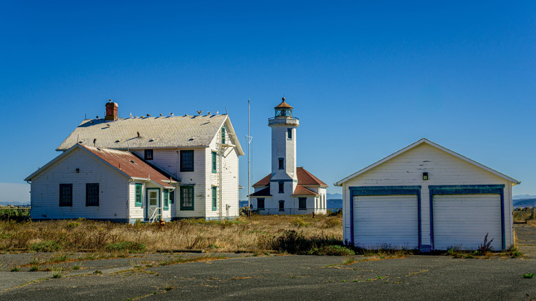 Abandoned historic lighthouse and keepers house at Fort Worden State Park in Washington