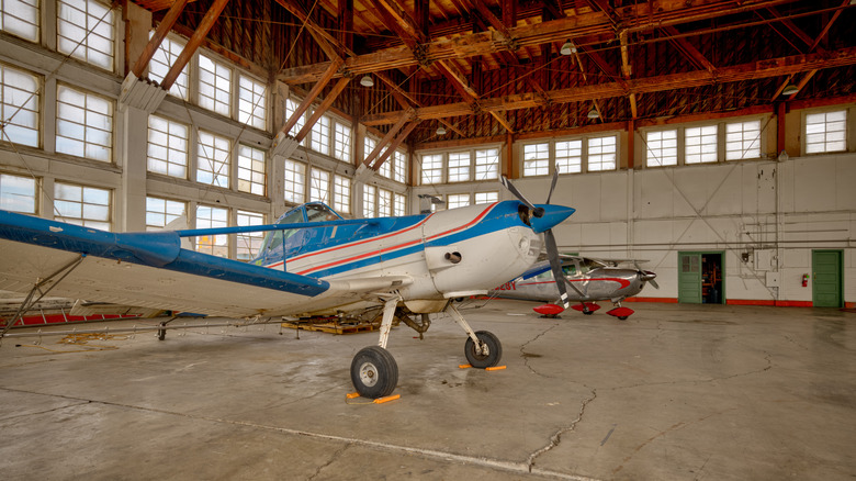 Interior view of two vintage planes in decommissioned hangars at the historic Wendover Airfield in the Utah desert.