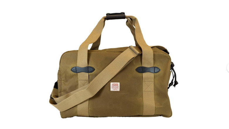 View of tan Filson Medium Tin Cloth Duffel Bag on white background