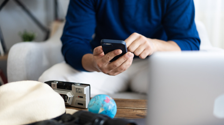 Man planning trip on smartphone