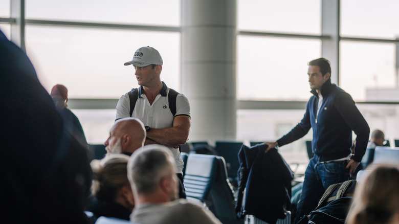 Men waiting at gate for standby flight