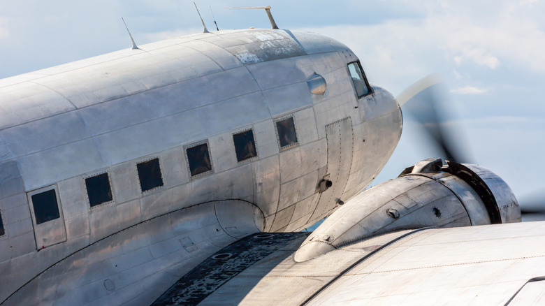 Close-up oldtimer piston-engined passenger aircraft with propellers whirring.
