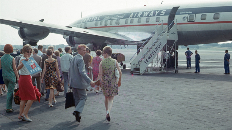 Passengers on tarmac boarding an airplane at the former Tempelhof Airport in 1966.