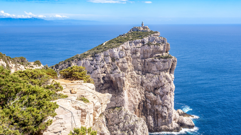 Capo Caccia lighthouse seen from a distance in Sardinia island, Italy