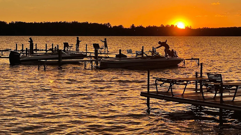Silhouettes of kids playing and jumping in Trout Lake, Wisconsin