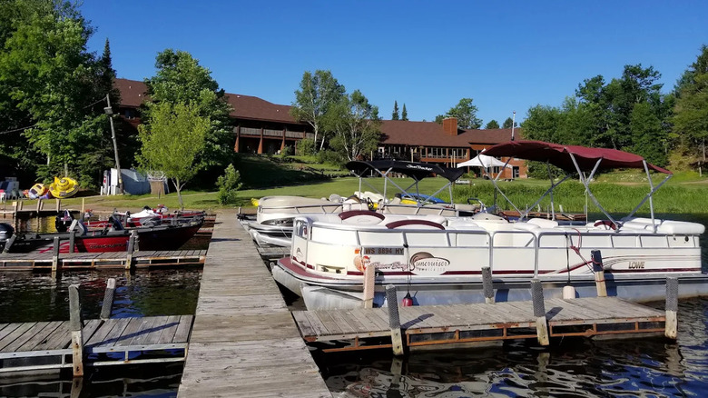 The exterior of Lakewoods Resort in Cable, viewed from the dock with pontoon boats