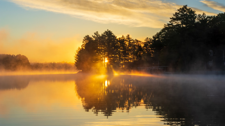 The sun rising over a misty lake in northern Wisconsin