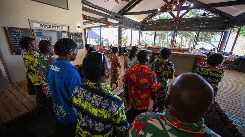 Fijians in colorful shirts singing hymns