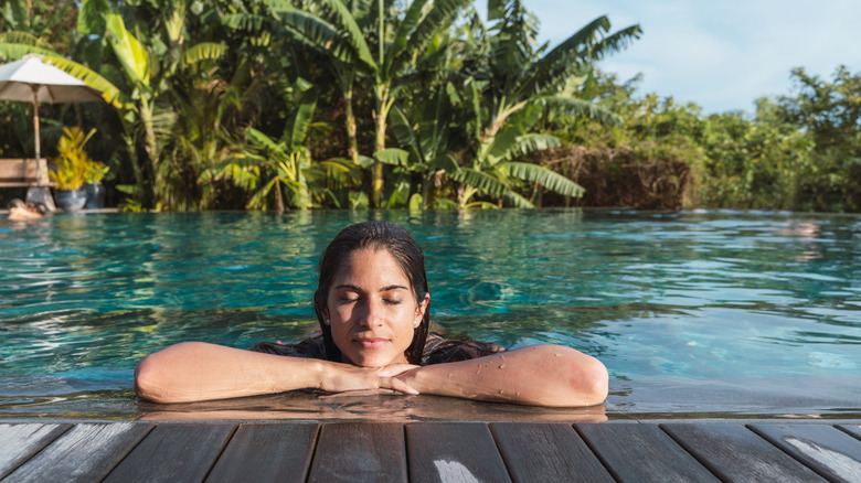 A traveler relaxing in a pool on vacation
