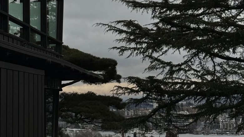 A side view of Canlis Restaurant with the Seattle skyline in the background.