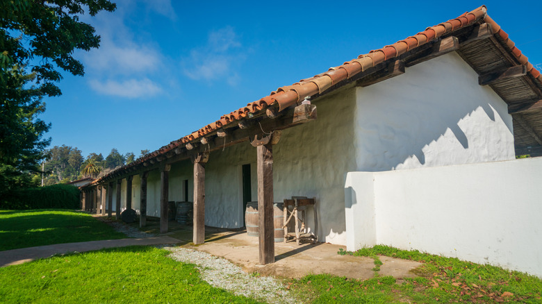 Trees cast shadows on the adobe at Santa Cruz Mission State Historic Park.