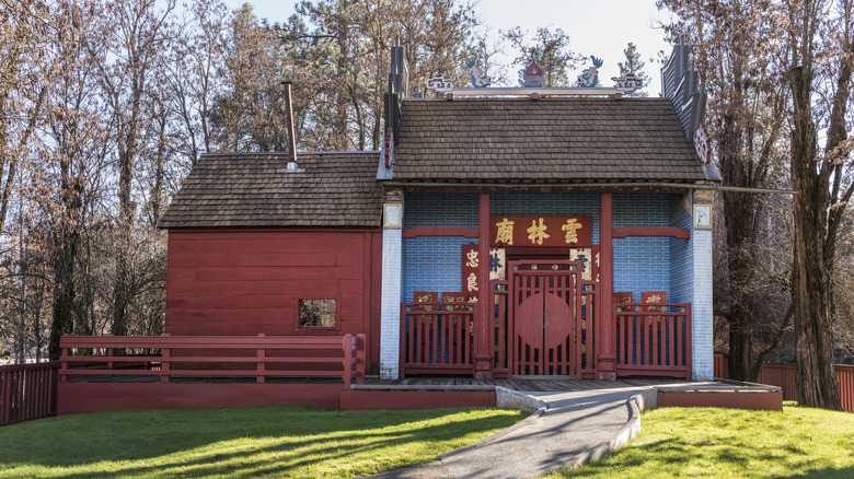 Trees and a lawn surround Weaverville Joss House State Historic Park's small Taoist shrine.