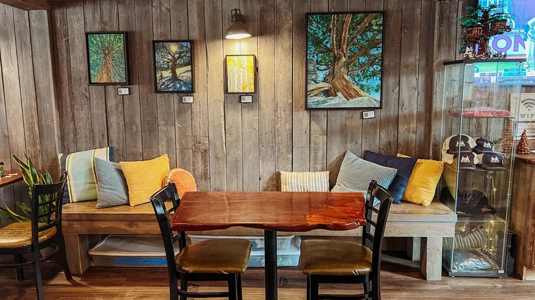 An interior view of rustic decor and tree paintings at Tree House Cafe in Lake Tahoe