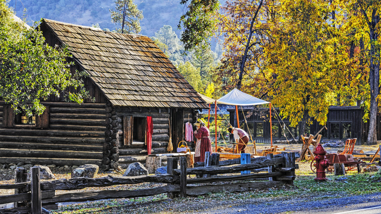 re-enactors in front of an authentic log cabin at California's Marshall Gold Discovery State Historic Park