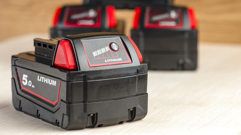 Close-up of a black and red lithium ion battery for a cordless drill