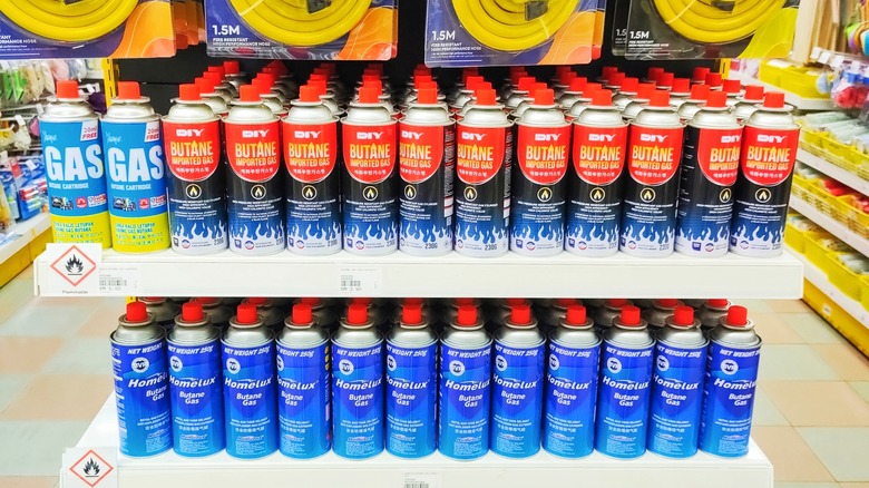 Butane gas canisters for sale on a shelf in Malaysia