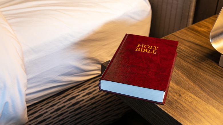 Red bible next to hotel bed