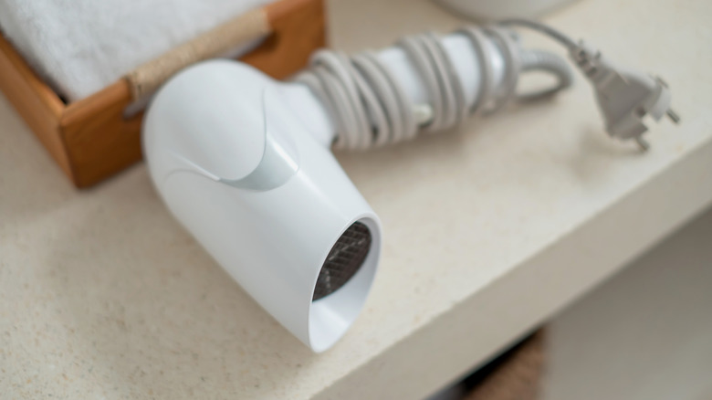 White hair dryer on hotel counter